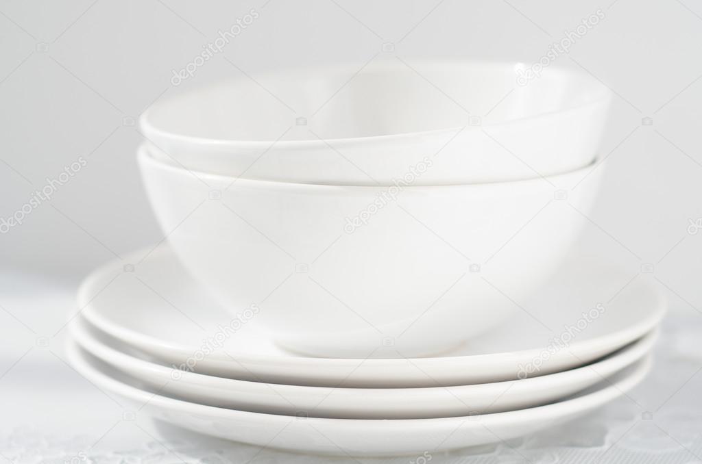 white plates and bowls on light table