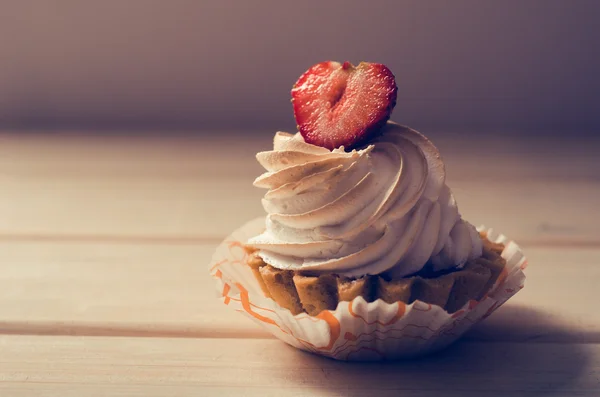 cake with white cream and fresh strawberries on table - retro instagram filter