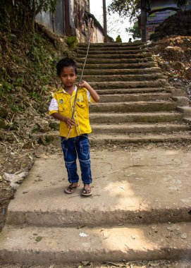 A boy playing alone on the stairways. This image has been captured on January-13-2018, from Dhamrai, Bangladesh, South Asia