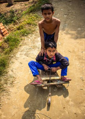 Boys are playing in a traditional toy car on the village street. This image has been captured on January-13-2018 by me, from Dhamrai, Bangladesh, South Asia