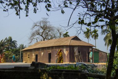 Men and women working in the yard. This image has been captured on January-13-2018 by me, from Dhamrai, Bangladesh, South Asia