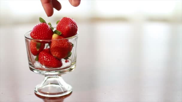Hand lässt eine Erdbeere fallen — Stockvideo