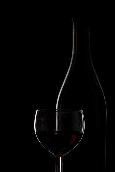 Bottle of wine and a glass of wine on a black background, minima — Stock Photo, Image