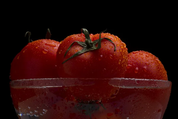 Red tomatoes in a glass bowl — Stock Photo, Image