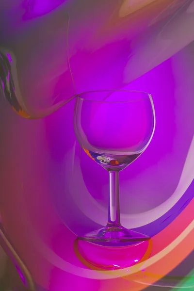 Wine glass on an abstract colored background — Stock Photo, Image