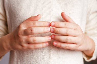Close-up is a childs fingers joined together. The concept of emotional well-being, a gesture of unity. Hand, nail care.