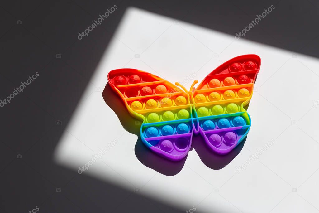 Rainbow butterfly. Lgbt flag symbol concept. Childrens toy Pop It..