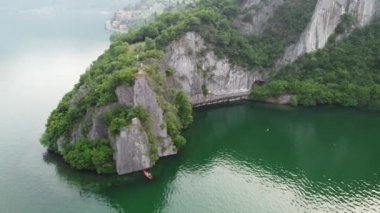 Bogn, Lombardy, İtalya 'nın Iseo Gölü' ndeki uçurum ve uçurumların insansız hava aracı görüntüsü. Dikey kayaların göle doğru süzüldüğü anlamlı bir körfez.