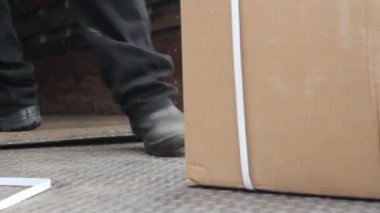 Operário colocando caixa no chão