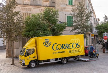 Porreres, Balearic Adaları / İspanya; 17 Kasım 2020: halka açık bir caddeye park edilmiş sarı posta kamyonu. İspanya 'da kamu posta servisi