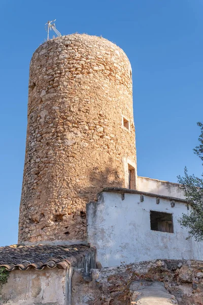 Old rustic stone mill restored on a sunny day. Island of Majorca, Spain