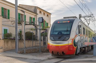 Sineu, Spain; april 14 2021: Train of the island of Mallorca passing through the town of Sineu, linking the cities of Palma and Manacor