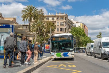 Palma de Mallorca, İspanya; 23 Nisan 2021: Palma de Mallorca Plaza Espana 'da otobüs durağı. Coronavirüs salgınından dolayı yüz cerrahisi maskesi takan yolcular ve sürücüler. Yeni normallik kavramı