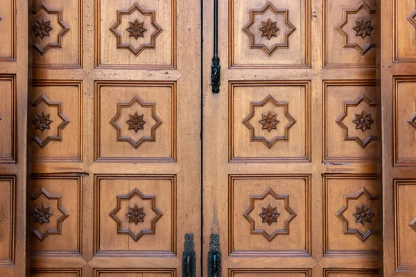 Carved wooden doors of access to the entrance of the church of the Majorcan town of Campos