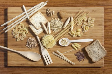 Art composition of pasta, grains,  whole grain bread, wooden kit clipart