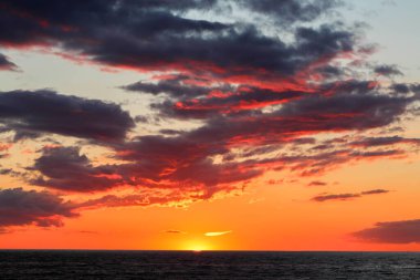 Baltık Denizi 'nin üzerinde dramatik ateşli bulutlarla gün batımı.