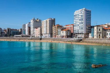 Gijon, Asturias, İspanya 'daki San Lorenzo Plajı. Renkli Seyahat Fotoğrafı Cantabrian Denizi kıyısındaki Sahil Tatil Köyü 'ndeki Uzun Modern Binalar Manzaralı.