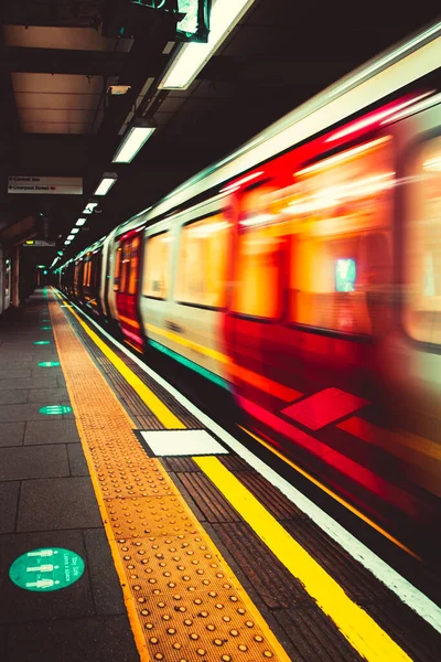 Londra Birleşik Devletleri Ocak 2021 Londra Metro metrosu istasyon platformuna yaklaşıyor, uzun süre hareketsiz kalarak hareket etti. Dikey karanlık karamsar çekim