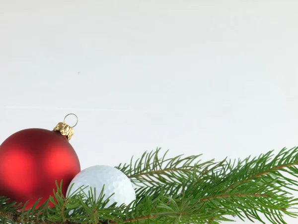 Christmas ball and golf ball. — Stock Photo, Image