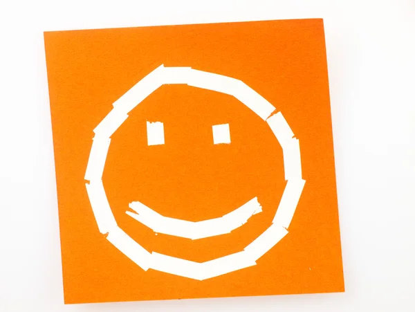 Sticky note with the symbol of a happy face. — Stock Photo, Image