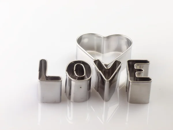 Word love from the molds to the dough. — Stock Photo, Image