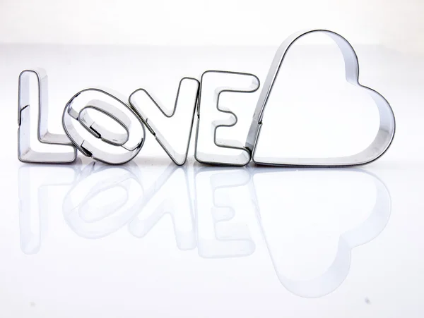 Word love and heart from the molds to the dough. — Stock Photo, Image