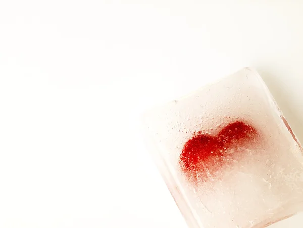 Red heart embedded in ice. — Stock Photo, Image