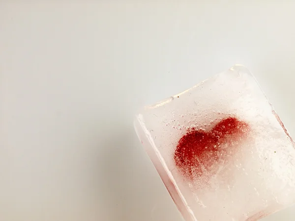 Red heart embedded in ice. — Stock Photo, Image