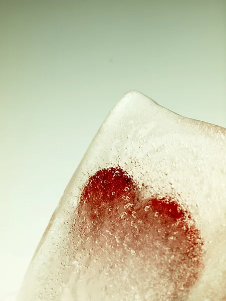 Red heart embedded in ice. — Stock Photo, Image