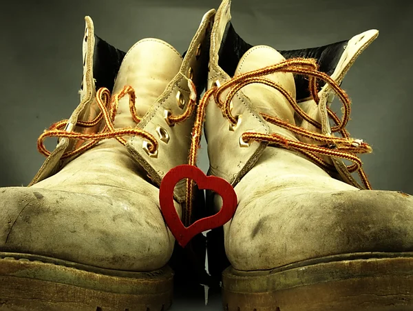 Pair of heavy military boots and red heart. — Stock Photo, Image