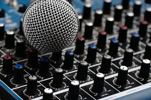 Audio mixer en een zilveren microfoon. — Stockfoto