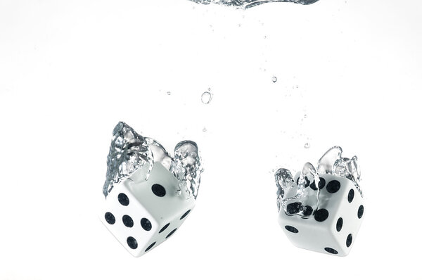 Dice dropped into the water, on a white background.