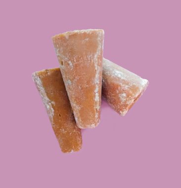 Pembe arka planda fotokopi alanı olan geleneksel Latin Amerika tatlı piloncillo (panela, jaggery)