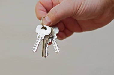 closeup of hand giving keys on ring