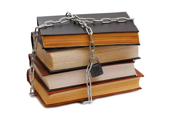 stack of various books wrapped by chain with padlock isolated on white background