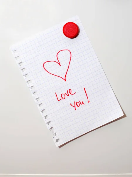 love you note on fridge door hold by red magnet