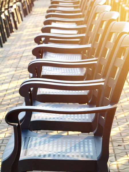 row of empty chairs outdoor before concert or show, toned, sunlight