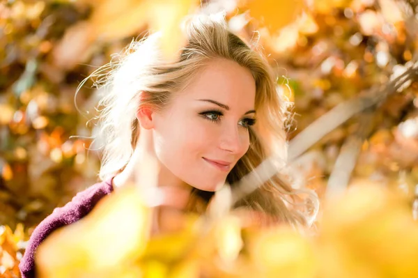 Young blond woman with bright hair in autumn color — Stock Photo, Image