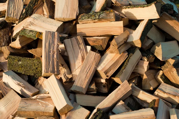 Firewood background - chopped firewood on a stack — Stock Photo, Image