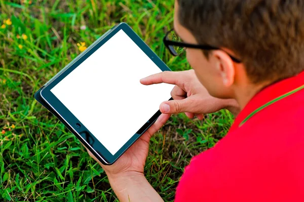 Young man using tablet computer on autumn  park — Stock Photo, Image
