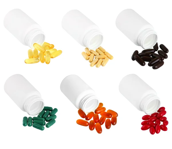 A set of pills spilling out of white plastic medicine bottle. — Stock Photo, Image
