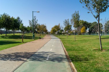 Sevilla 'daki Ro Guadaira Parkı (Endülüs, İspanya). Çimenli büyük bir park, çift yönlü bisiklet yolu, banklar, açık hava spor makineleri ve büyük ağaçlar. Şehrin güneyinde yer alan park.