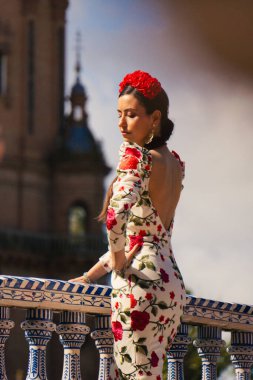 Seville, Spain; April 5th 2025: Woman wearing a flamenco dress posing. Traditional outfit from the Seville Fair.