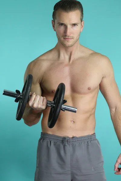 Muscular man holding a dumbbell — Stock Photo, Image