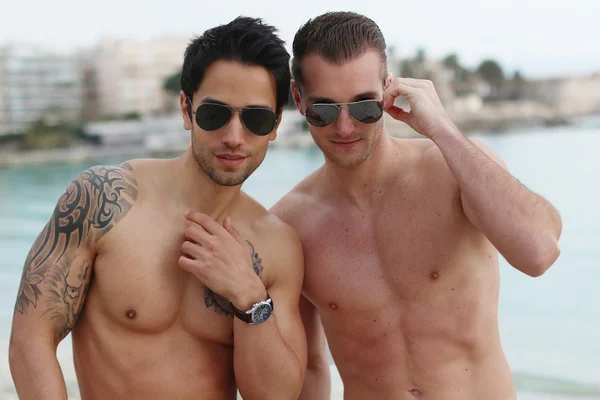 Summertime - two womanizer posing on the beach — Stock Photo, Image