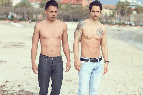 Summertime - two sexy male posing on the sand — Stock Photo, Image