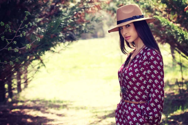 Young fashion woman standing in the forest — Stock Photo, Image