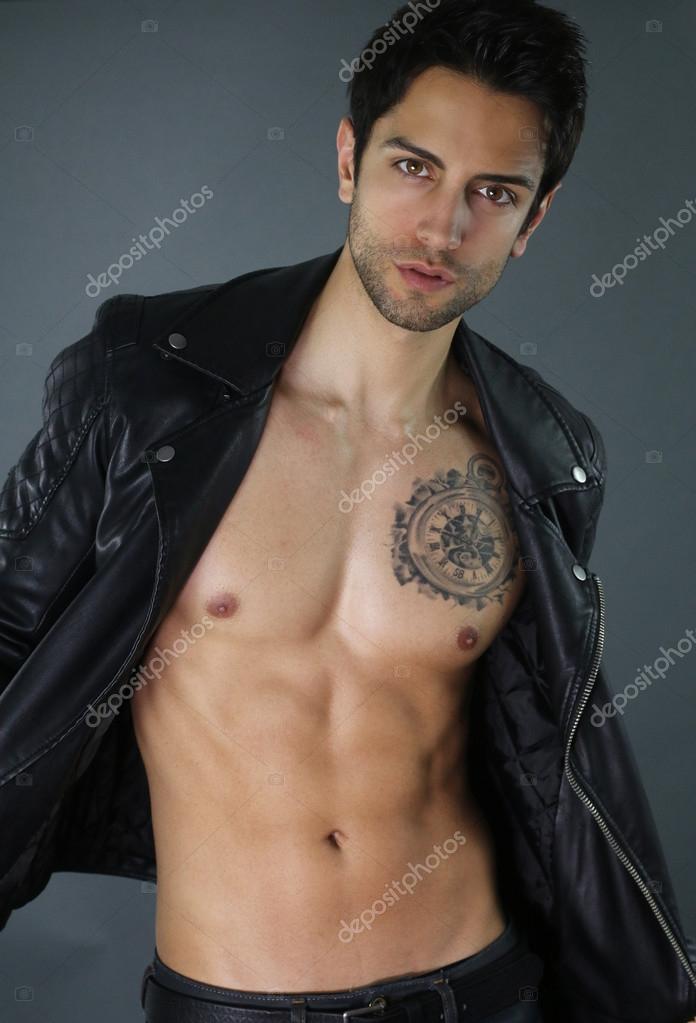 Sexy bad boy opening his leather jacket Stock Photo by ©rdrgraphe 108938444