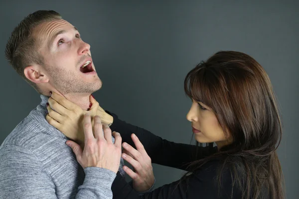 Young woman strangling her boyfriend — Stock Photo, Image