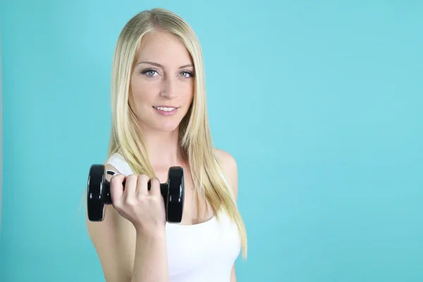 Beautiful blonde holding a dumbbell — Stock Photo, Image